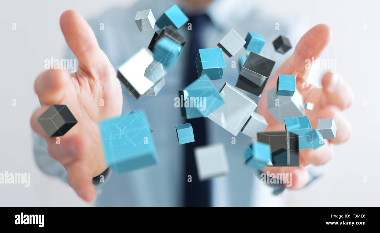Businessman on blurred background holding floating blue shiny cube network 3D rendering Stock Photo