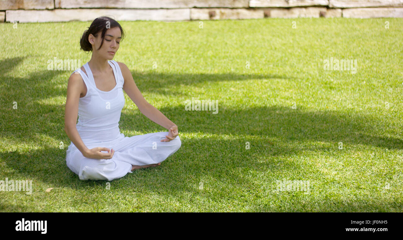 Young woman meditating in nature Stock Photo - Alamy