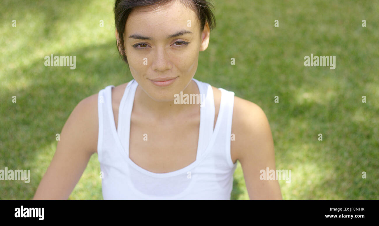 Calm young woman in white blouse with grin Stock Photo