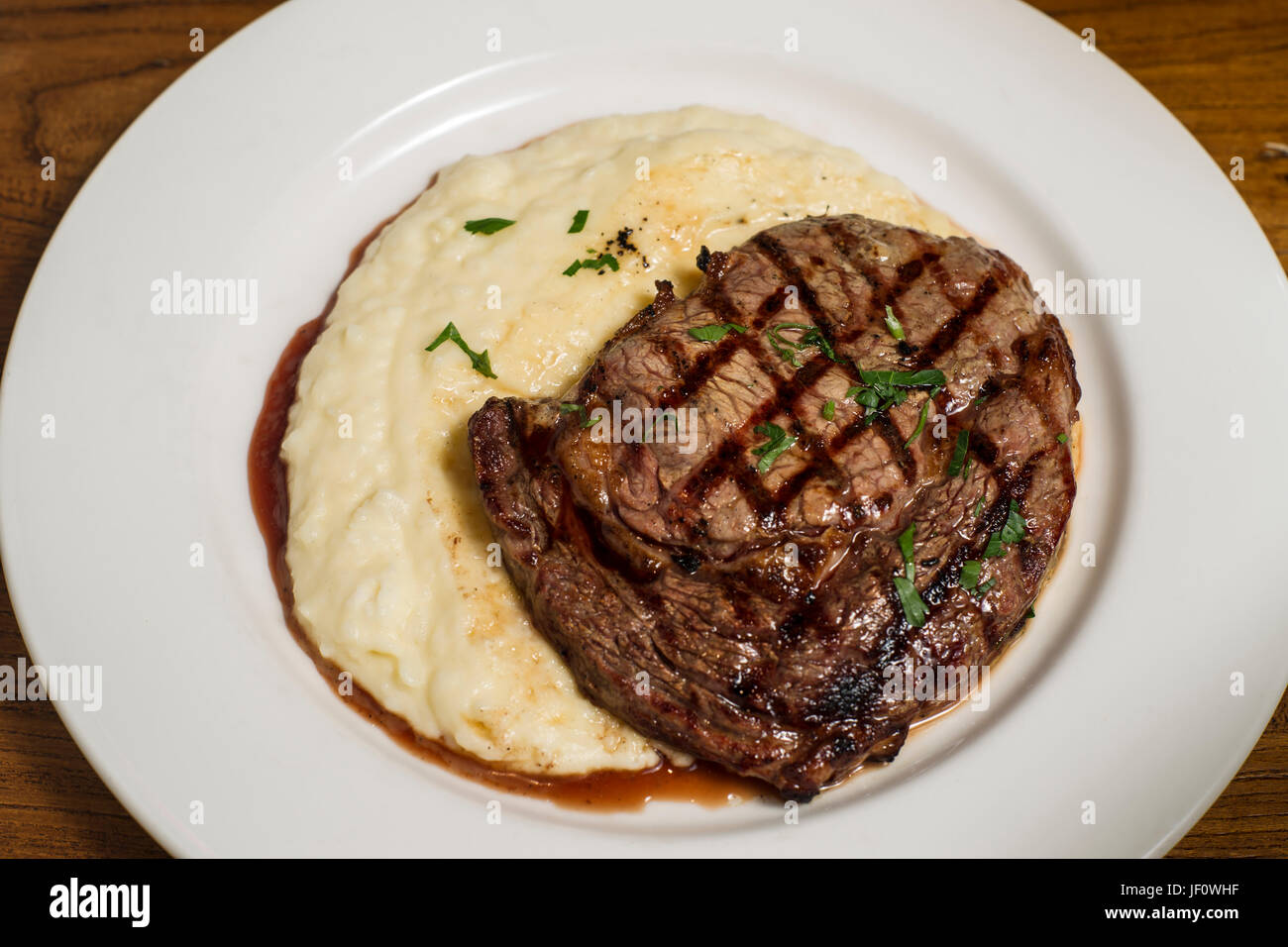 Beef steak with mash potato on white plate Stock Photo - Alamy