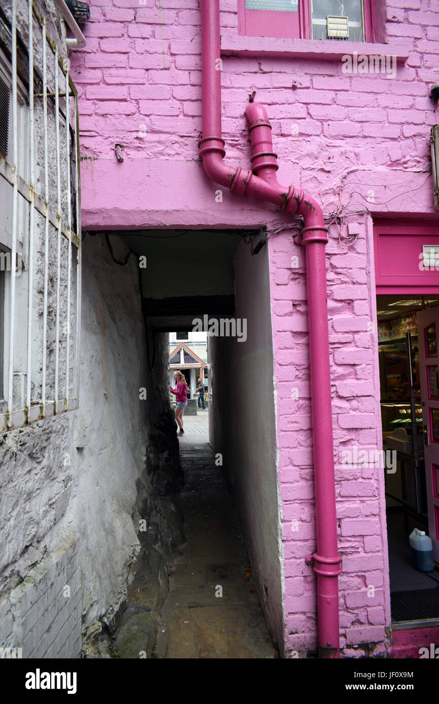 Pink painted passageway and drainpipe, Lake District, Cumbria, UK Stock Photo