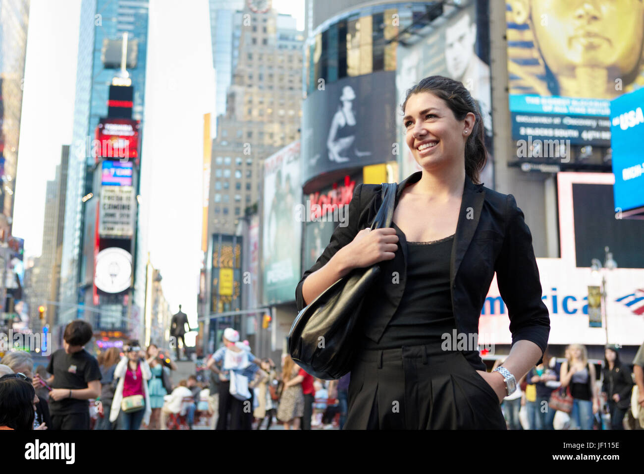 Smiling woman on city street Stock Photo - Alamy