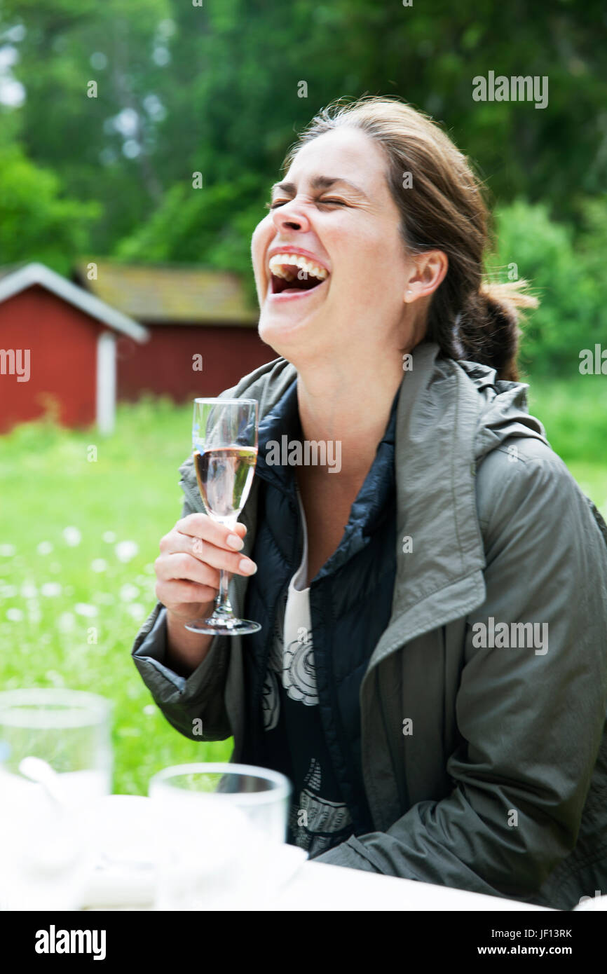 Laughing woman with wine glass Stock Photo - Alamy