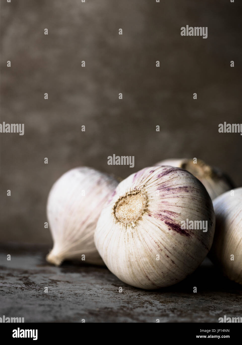 Garlic on grey background Stock Photo - Alamy