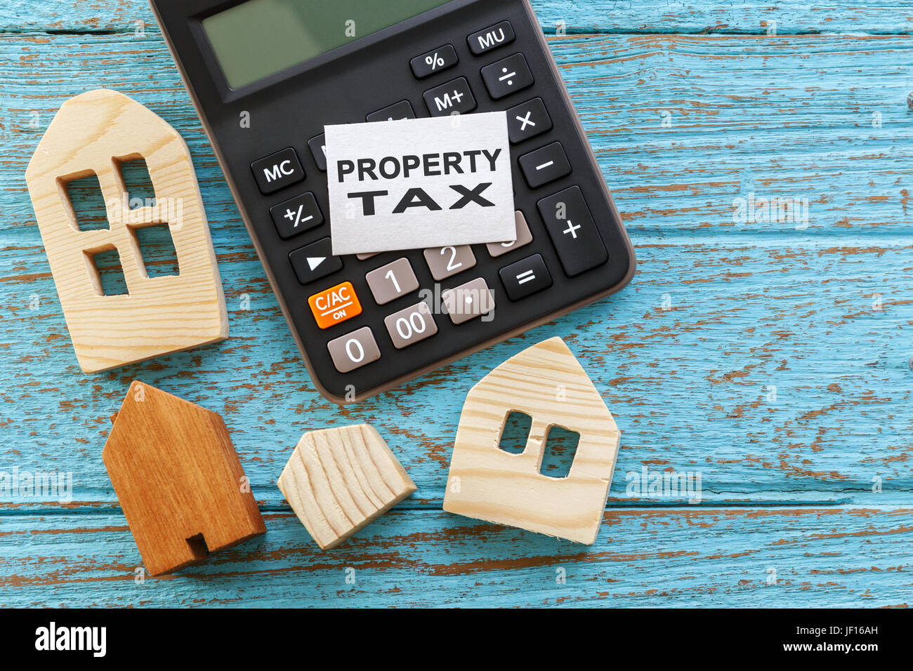 Wood house with calculator for property tax concept Stock Photo Alamy