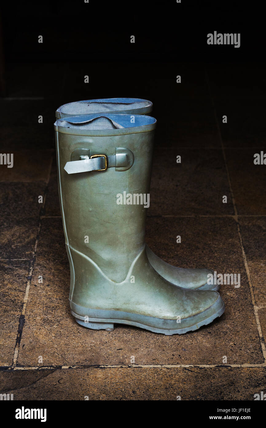 Pair of green Wellington boots standing on stone floor Stock Photo - Alamy