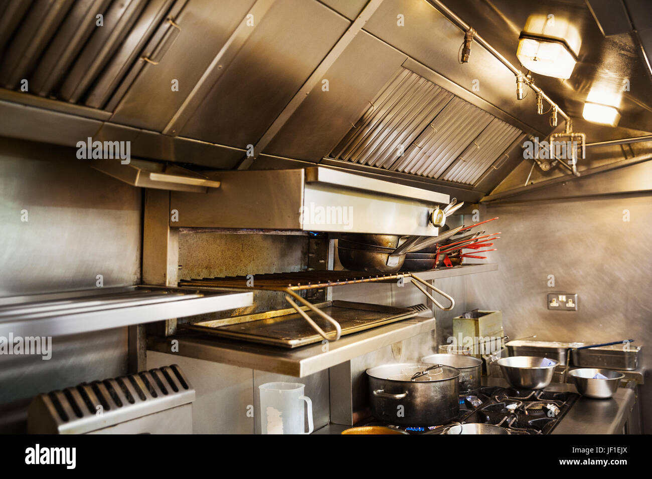 Interior view of restaurant kitchen pots on stovetop 