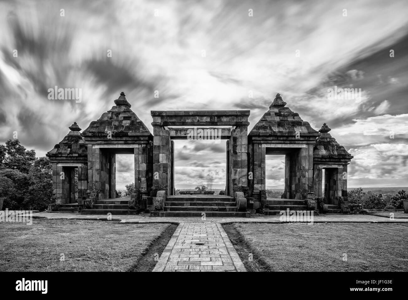 Breathtaking black and white photo of Ratu Boko, Indonesia, with a sky laden with low and flat clouds. Stock Photo