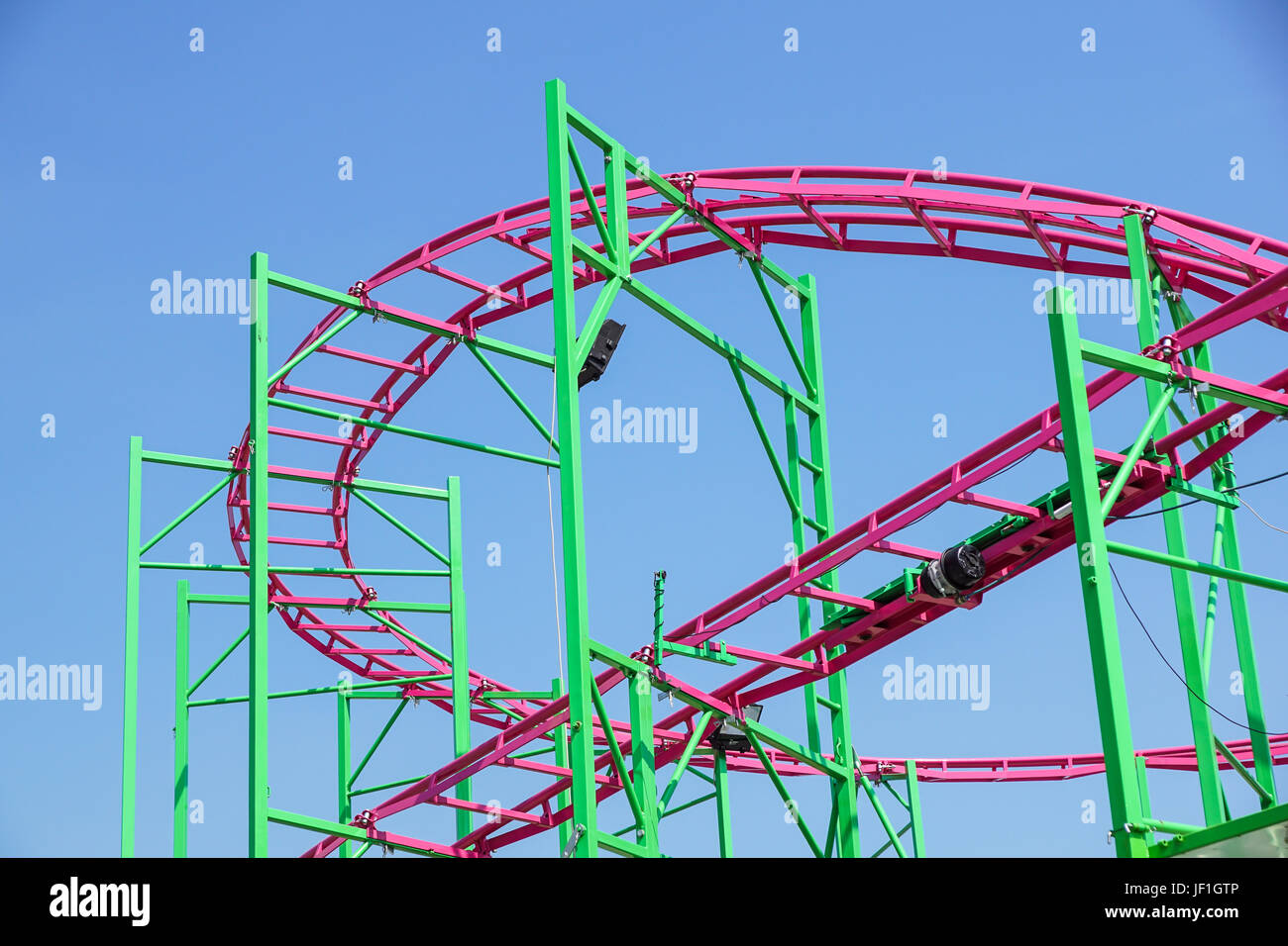 Rollercoaster track rail against a brilliant blue sky Stock Photo