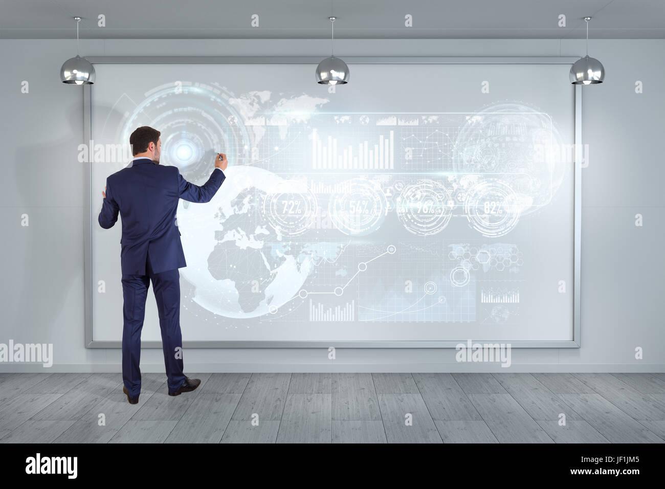 Businessman in modern interior using graph screens interface on a board ...