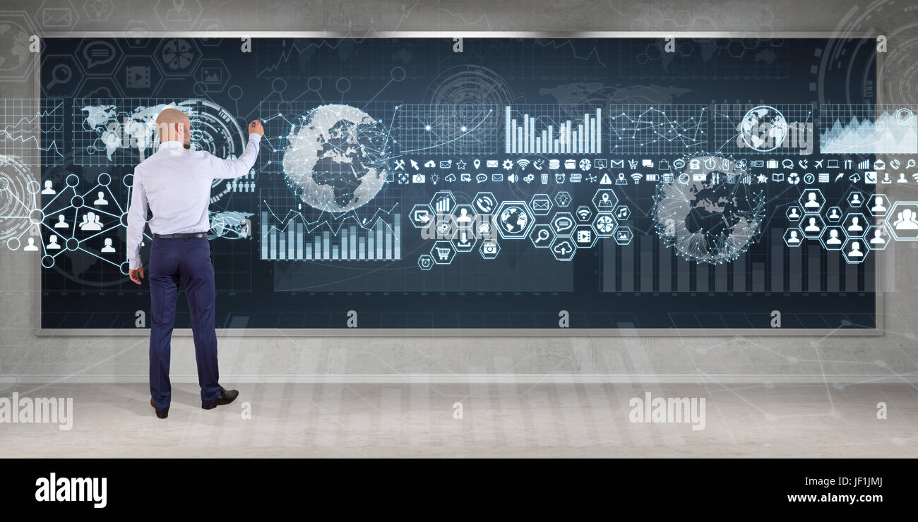 Businessman in modern interior using graph screens interface on a board ...