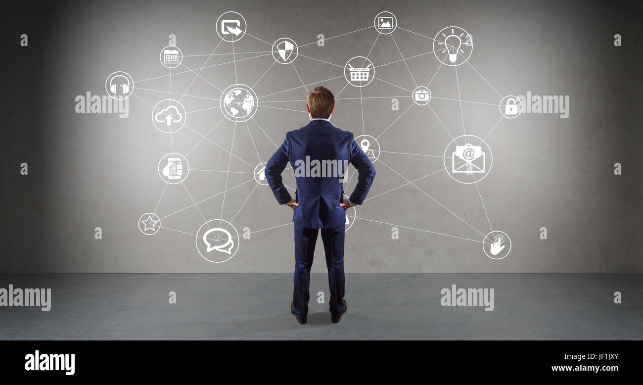Businessman in modern interior using social network interface on a wall 3D rendering Stock Photo