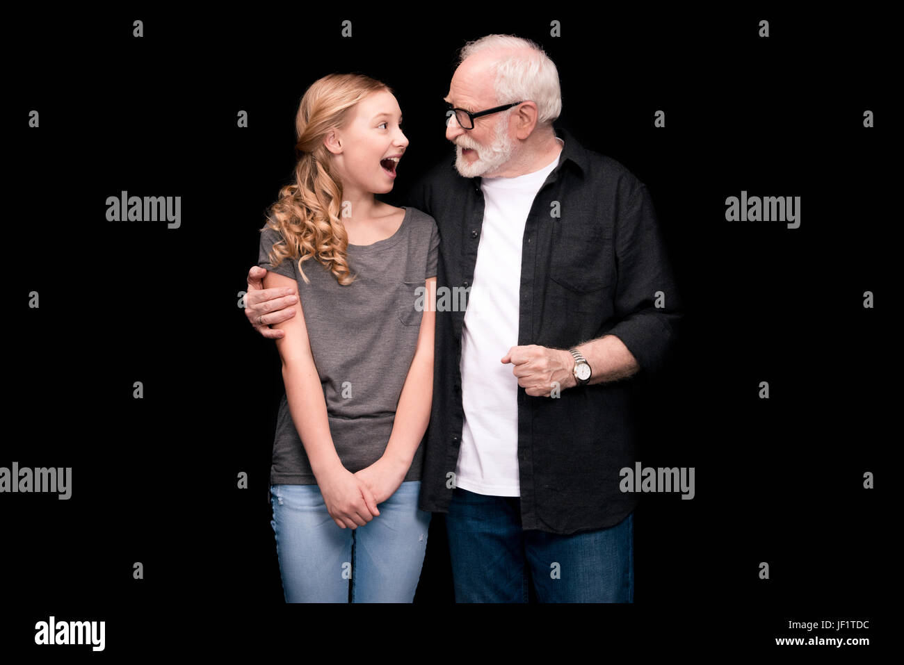 Studio portrait of 7 year old girl holding 7 week old baby Stock Photo. gra...