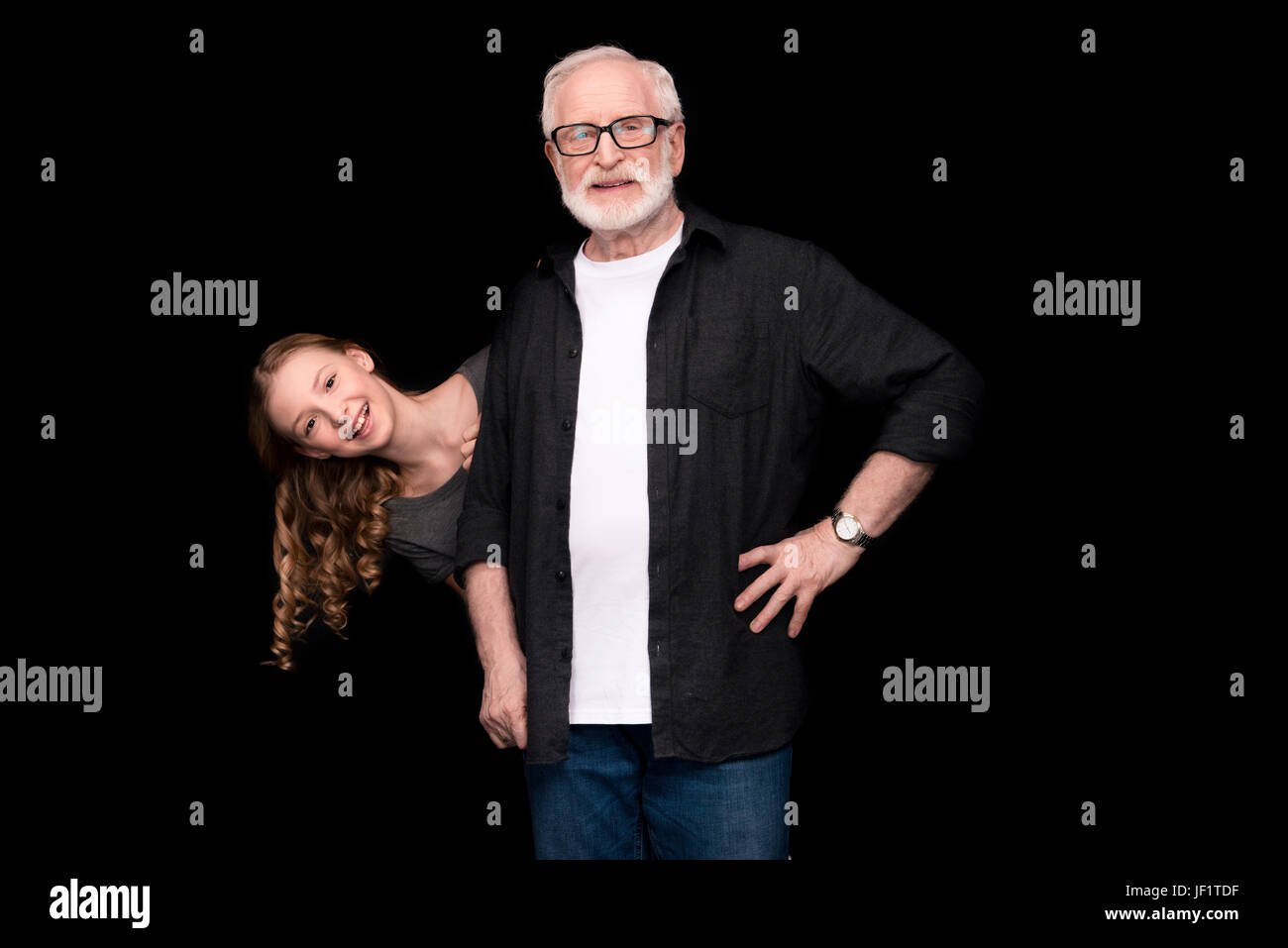 grandfather and smiling granddaughter isolated on black Stock Photo - Alamy