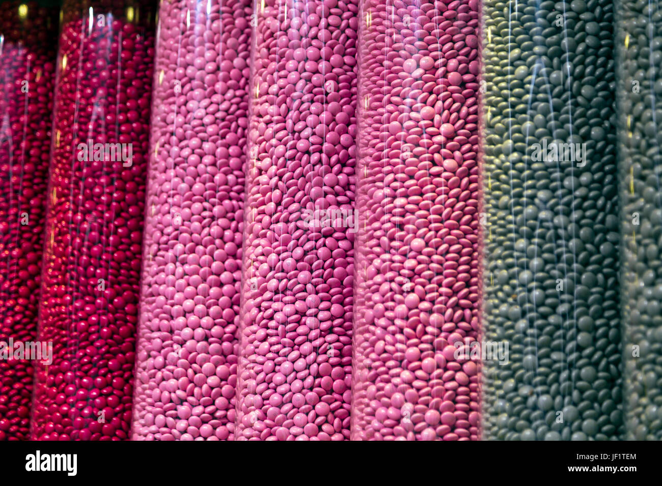 Tubes of colourful chocolate button candy at M&M's World in Leicester Square, London, UK Stock Photo
