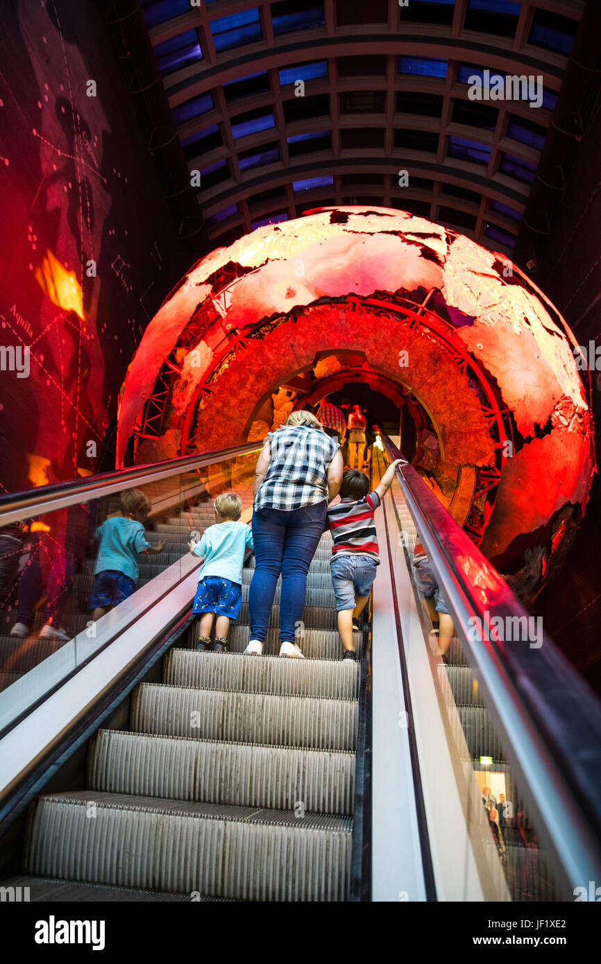 Family on Escalator passing through Planet Earth in the Natural History Museum London Stock Photo
