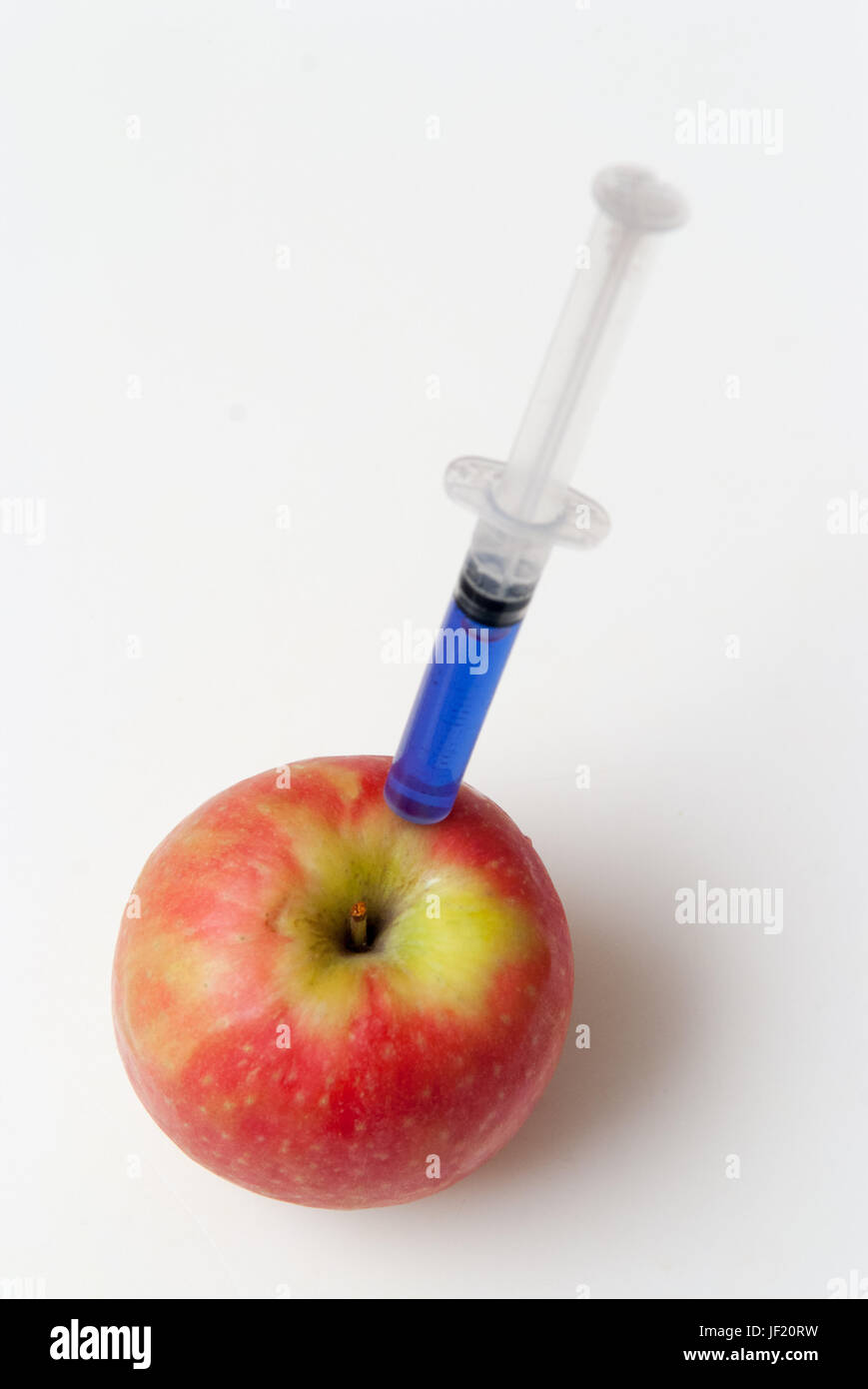 Gm food concept, additives and chemicals being injected into fruit Stock Photo