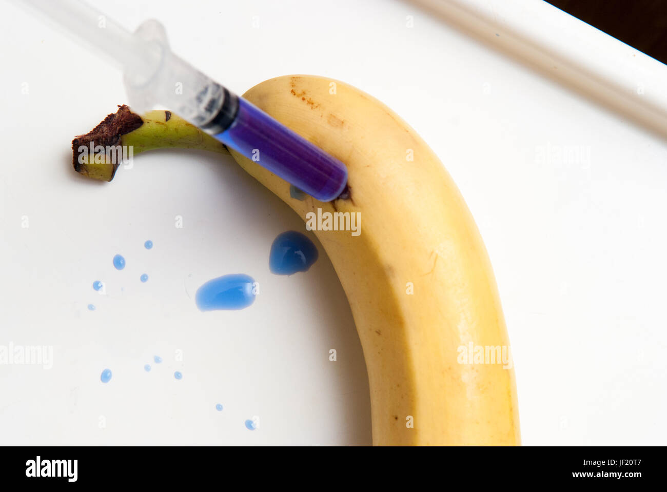 Gm food concept, additives and chemicals being injected into fruit Stock Photo