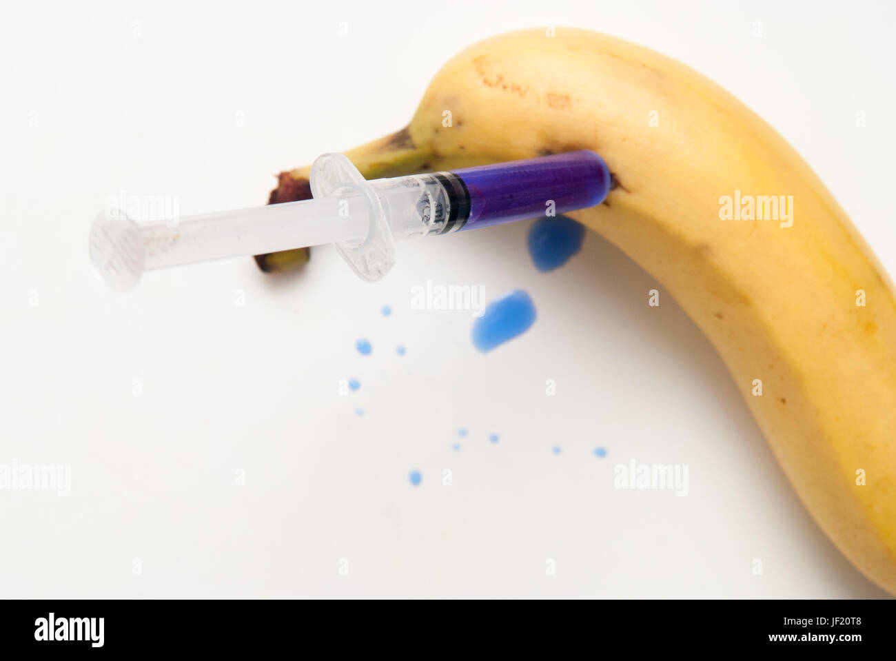Gm food concept, additives and chemicals being injected into fruit Stock Photo