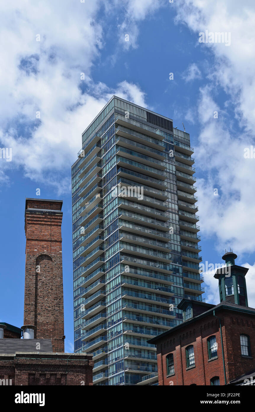 Modern condominium rising above an old industrial building Stock Photo ...