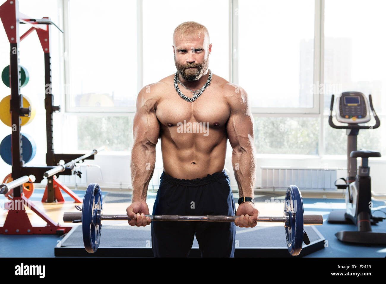 bodybuilder in the gym training with bar Stock Photo