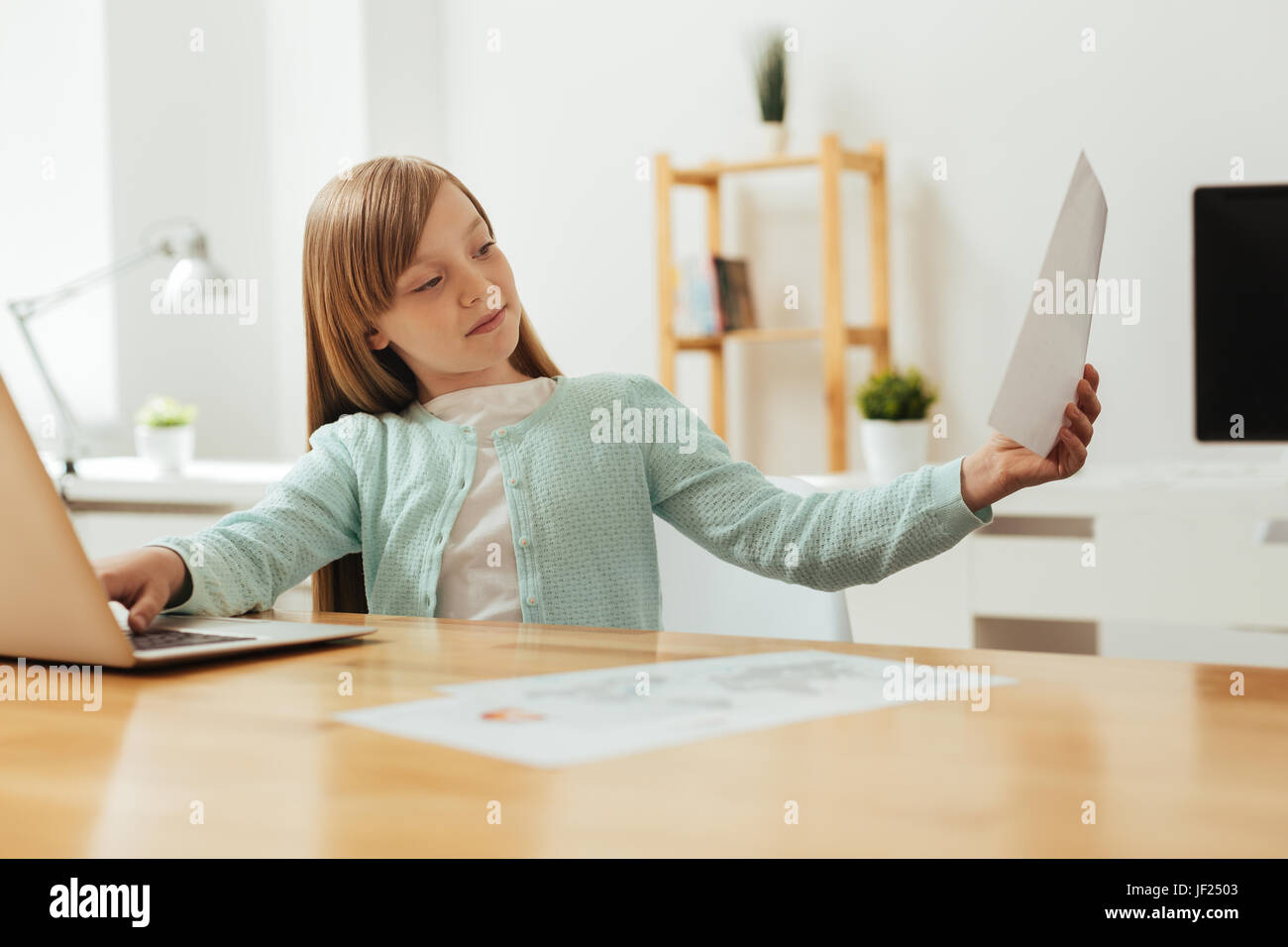 Enchanting smart girl perusing an article Stock Photo - Alamy