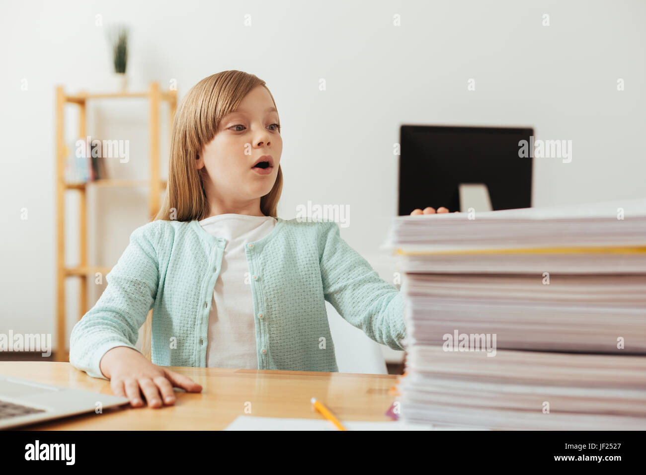 Humorous lovely child have a lot of assignments Stock Photo