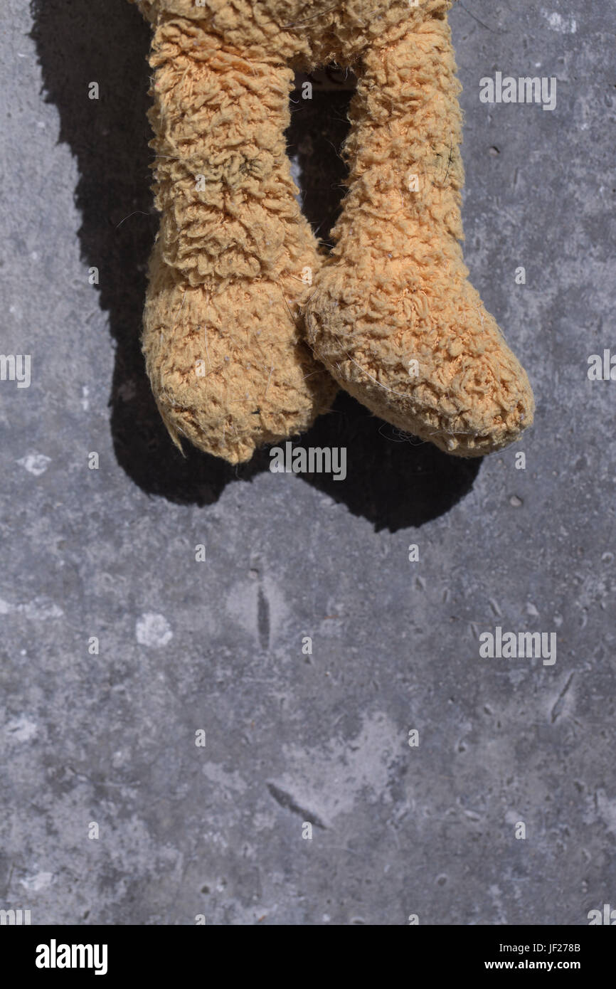 Old plush toy lays on the floor. Best use as a book cover or poster. Stock Photo