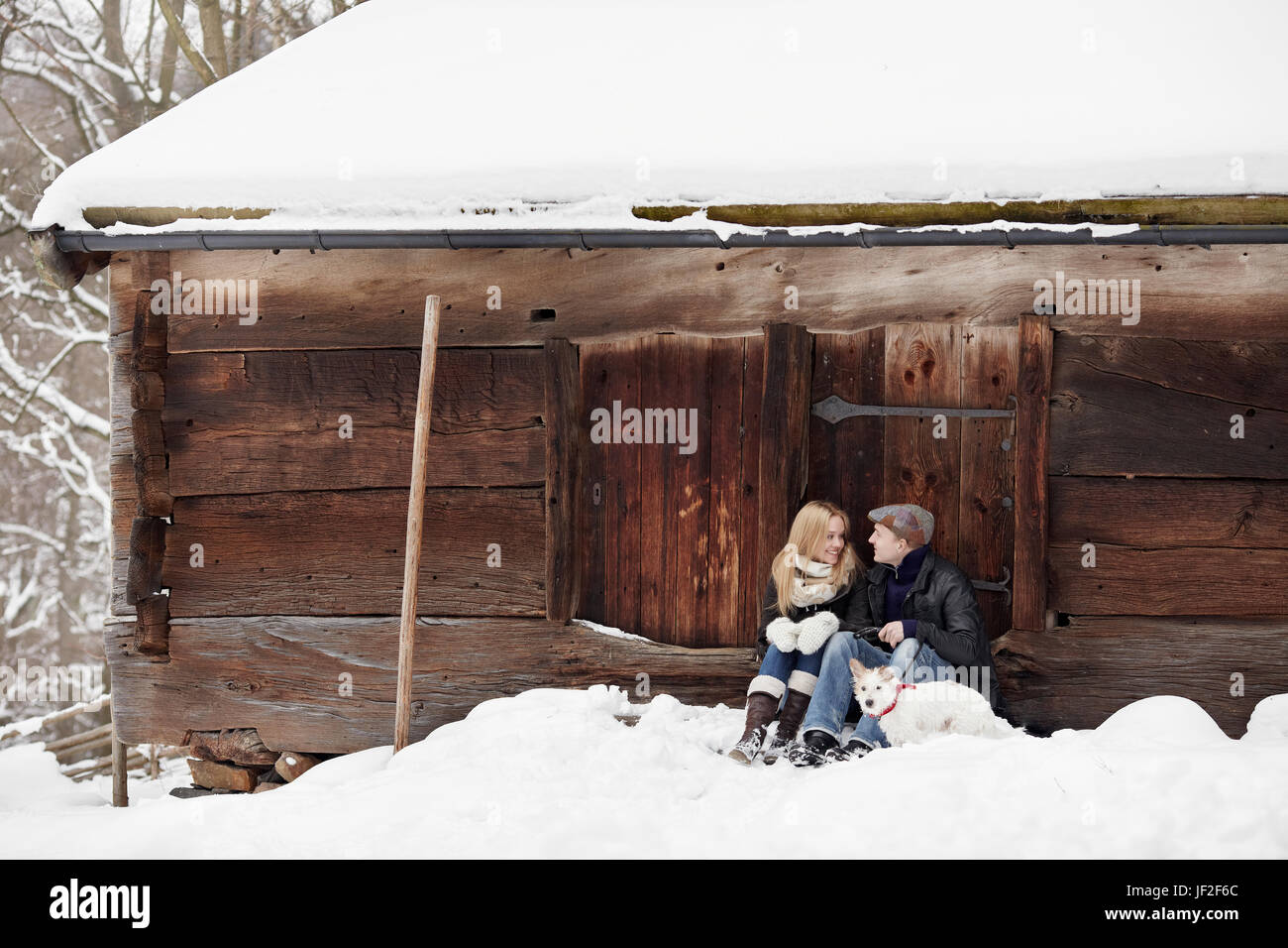 Young couple at winter with dog Stock Photo - Alamy