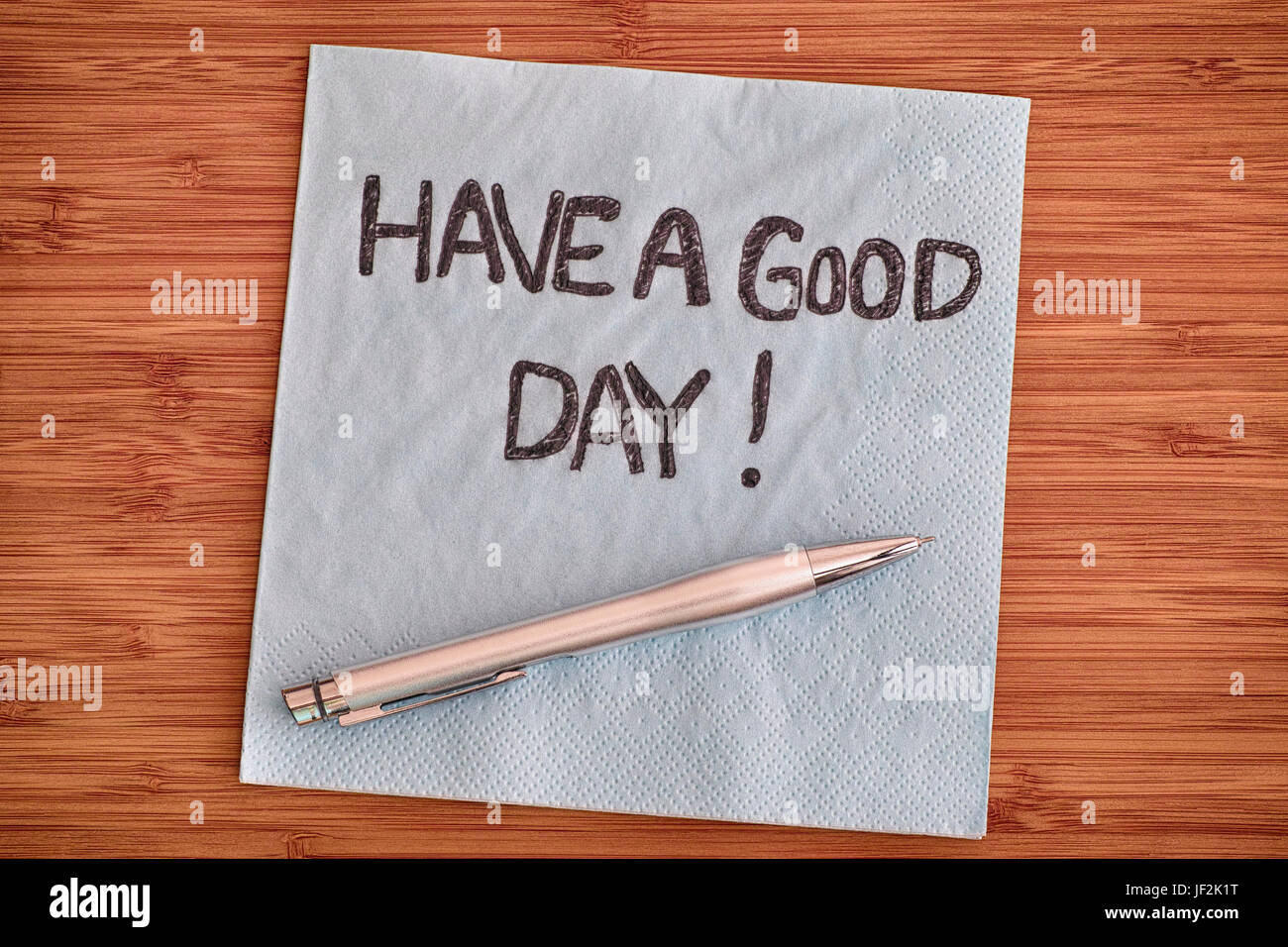 Have a good day! Handwriting on a napkin. Close up. Stock Photo