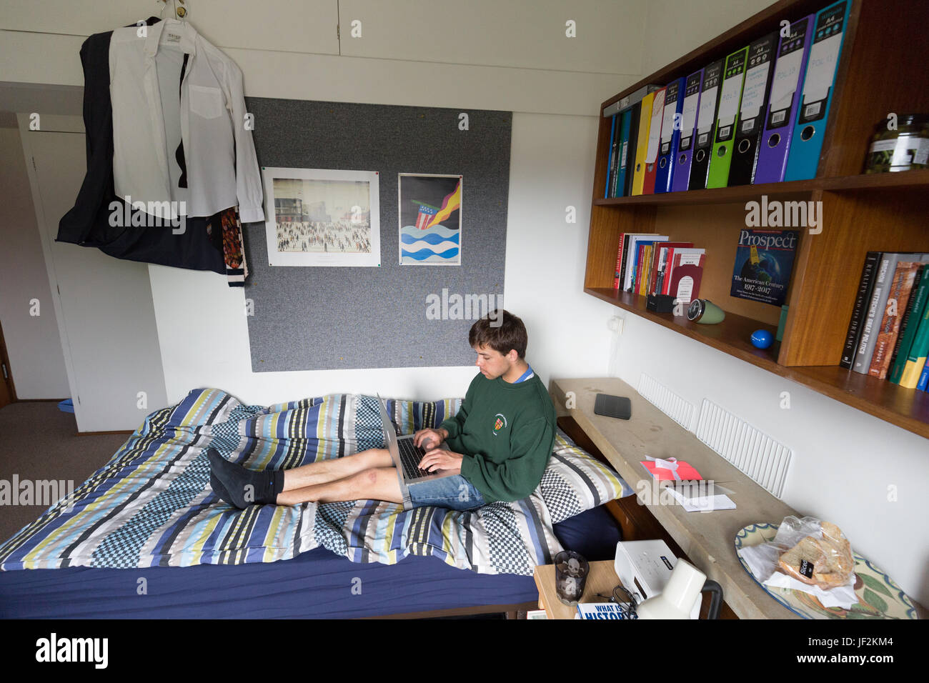 Cambridge University student studying on laptop in University accommodation bedroom, Queens College Cambridge University, Cambridge England UK Stock Photo