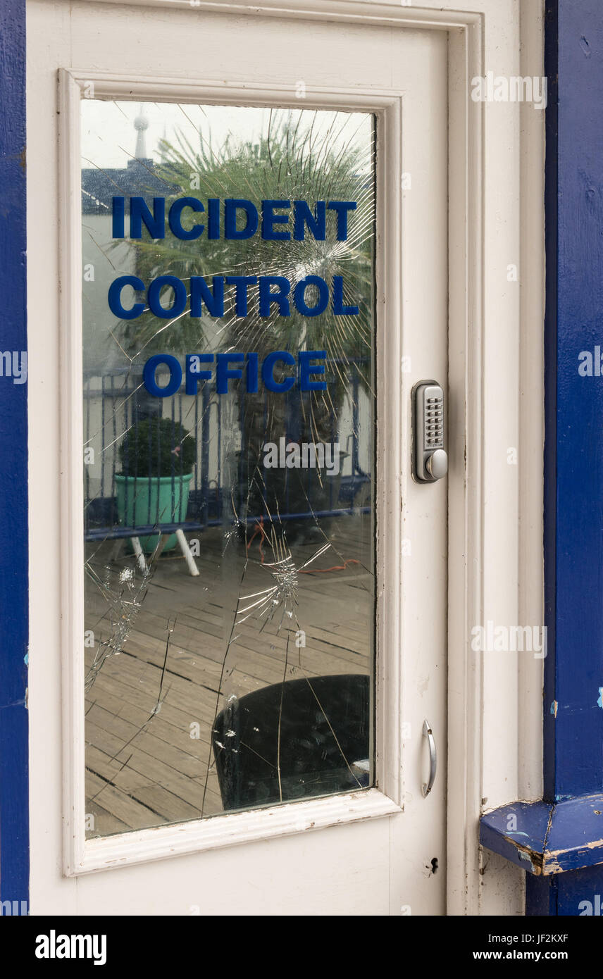 Funny sign on broken glass door Stock Photo