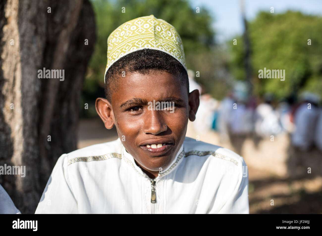 Portrait of young boy dressed in traditional kanzu and kofia (embroidered hat) attends the Maulidi celebrations on Lamu island, Kenya Stock Photo