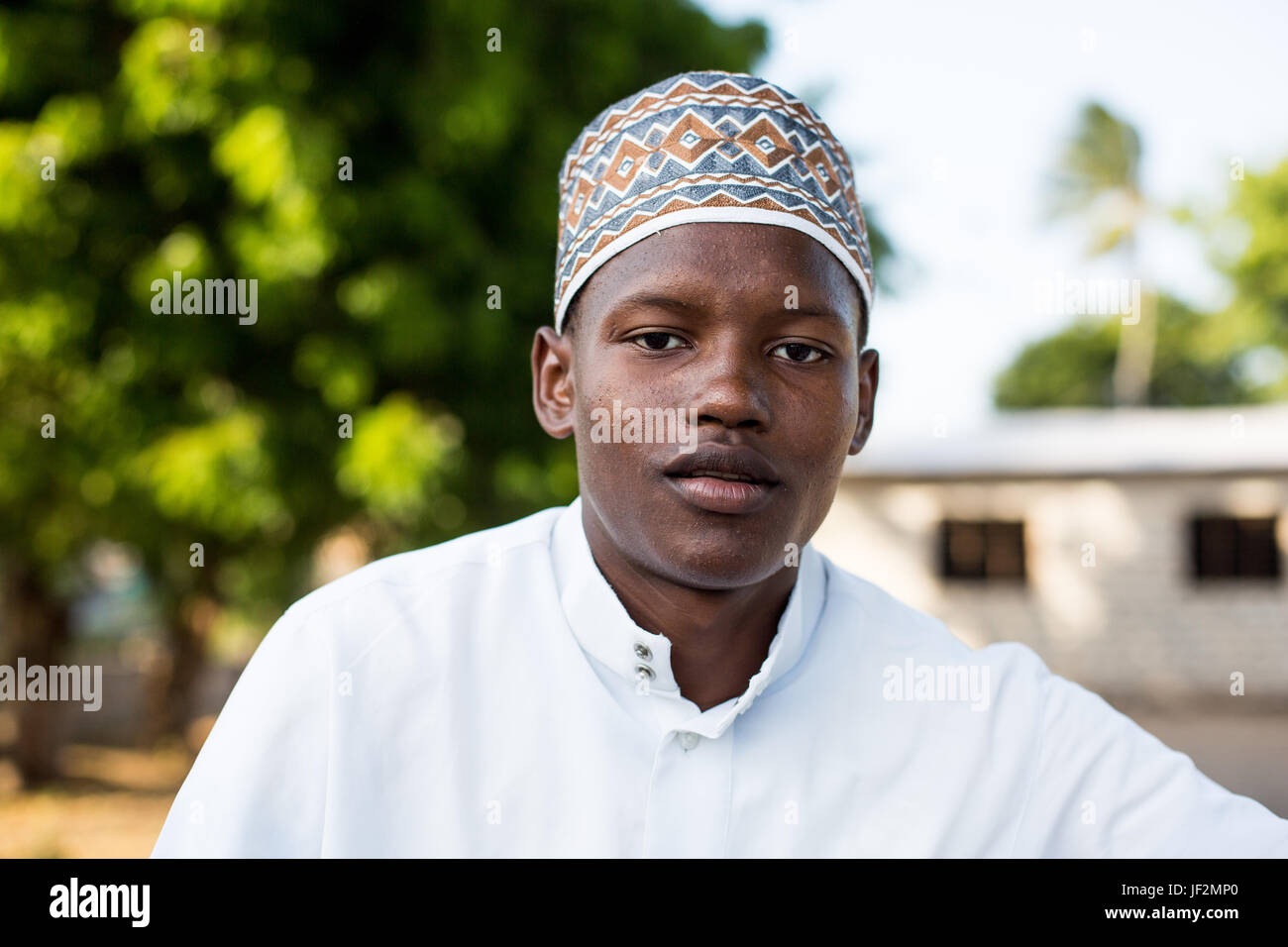 Portrait of young boy dressed in traditional kanzu and kofia (embroidered hat) attends the Maulidi celebrations on Lamu island, Kenya Stock Photo