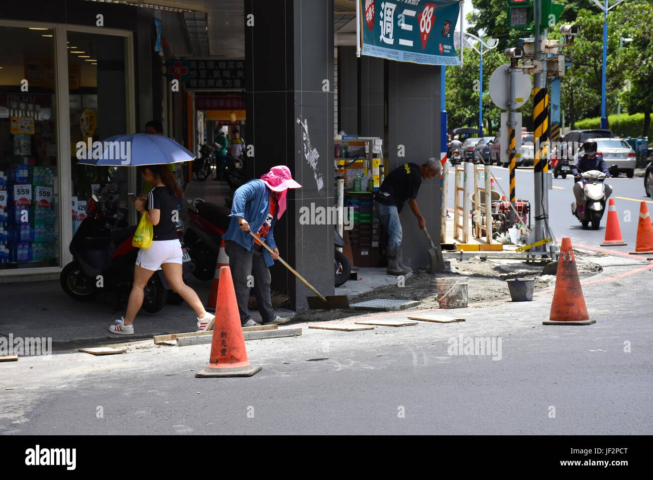 Woman construction worker working hard in summer heat of 93 F and
