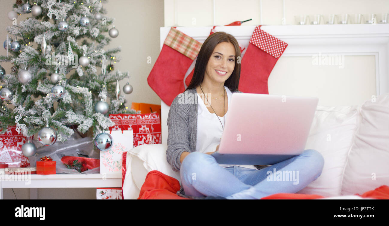 Relaxed young woman working on her laptop Stock Photo - Alamy