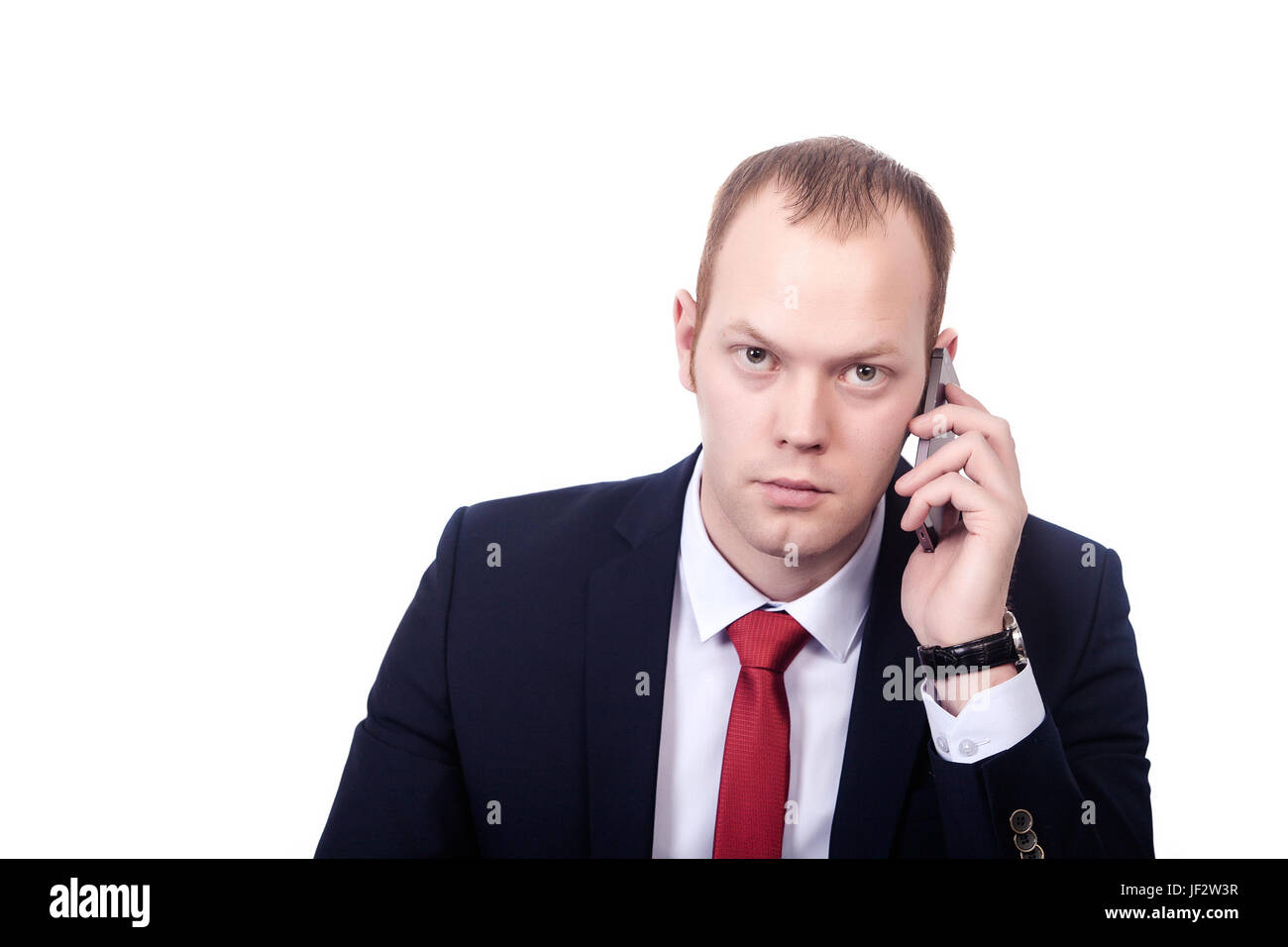 Handsome psychologist in elegant formal suit having phone conversation with colleague discussing important details. Stock Photo