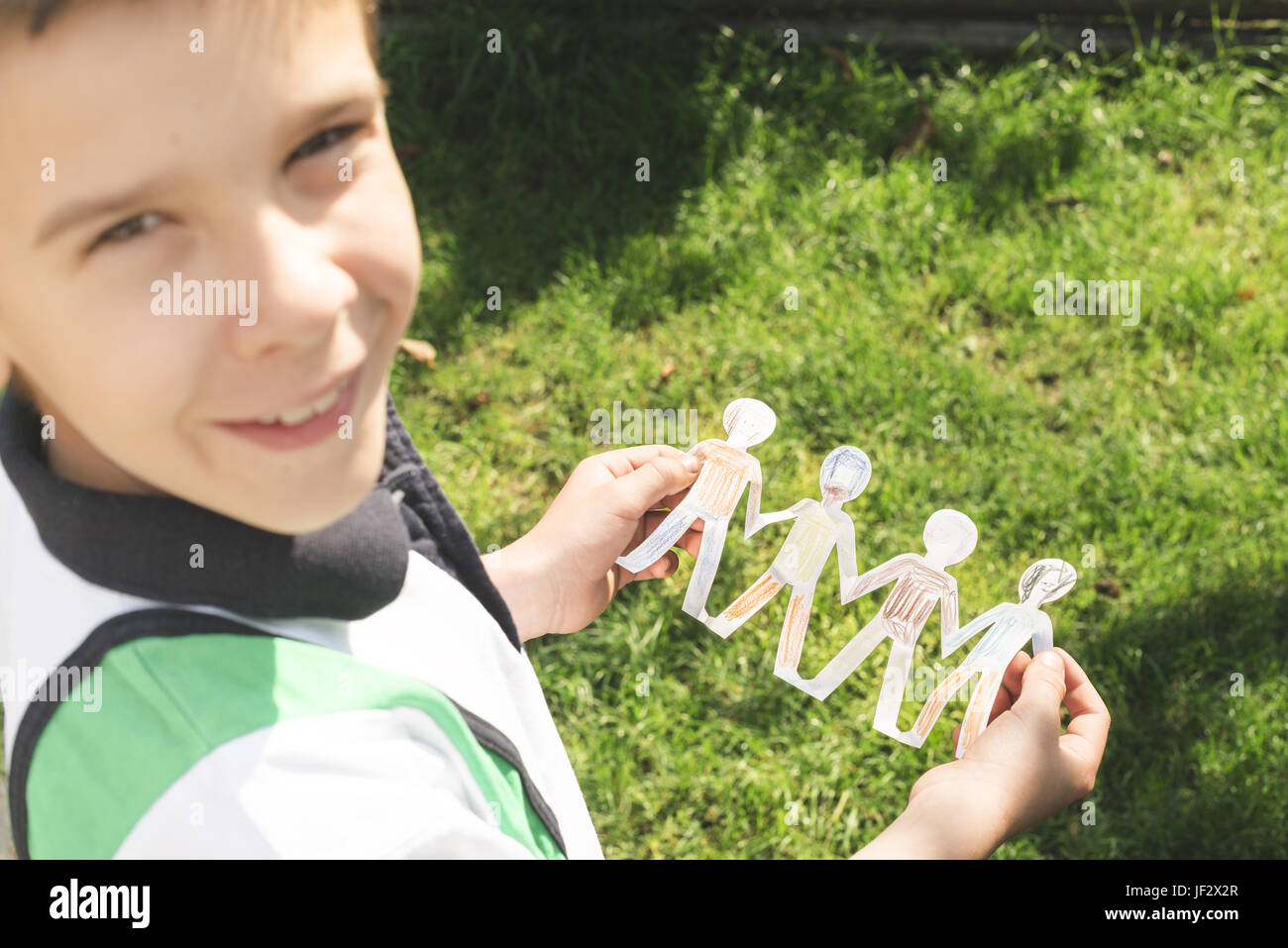 Child hold paper made people figures Stock Photo