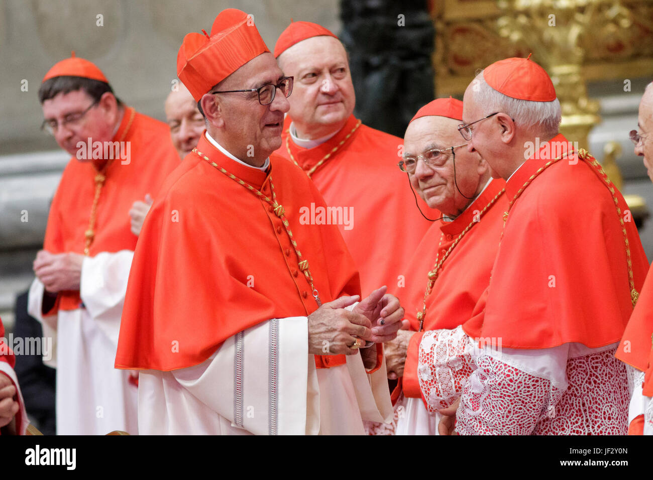 Vatican City, Vatican. 28th June, 2017. New Cardinal Juan Jose Omella, Archbishop of Barcelona, greets by other Cardinals after he received the red three-cornered biretta hat from Pope Francis during the Ordinary Public Consistory in St. Peter's Basilica in Vatican City, Vatican on June 28, 2017. The 5 new cardinals are below 80 and would therefore be entitled to vote in a conclave to decide a new pontiff. Credit: Giuseppe Ciccia/Pacific Press/Alamy Live News Stock Photo