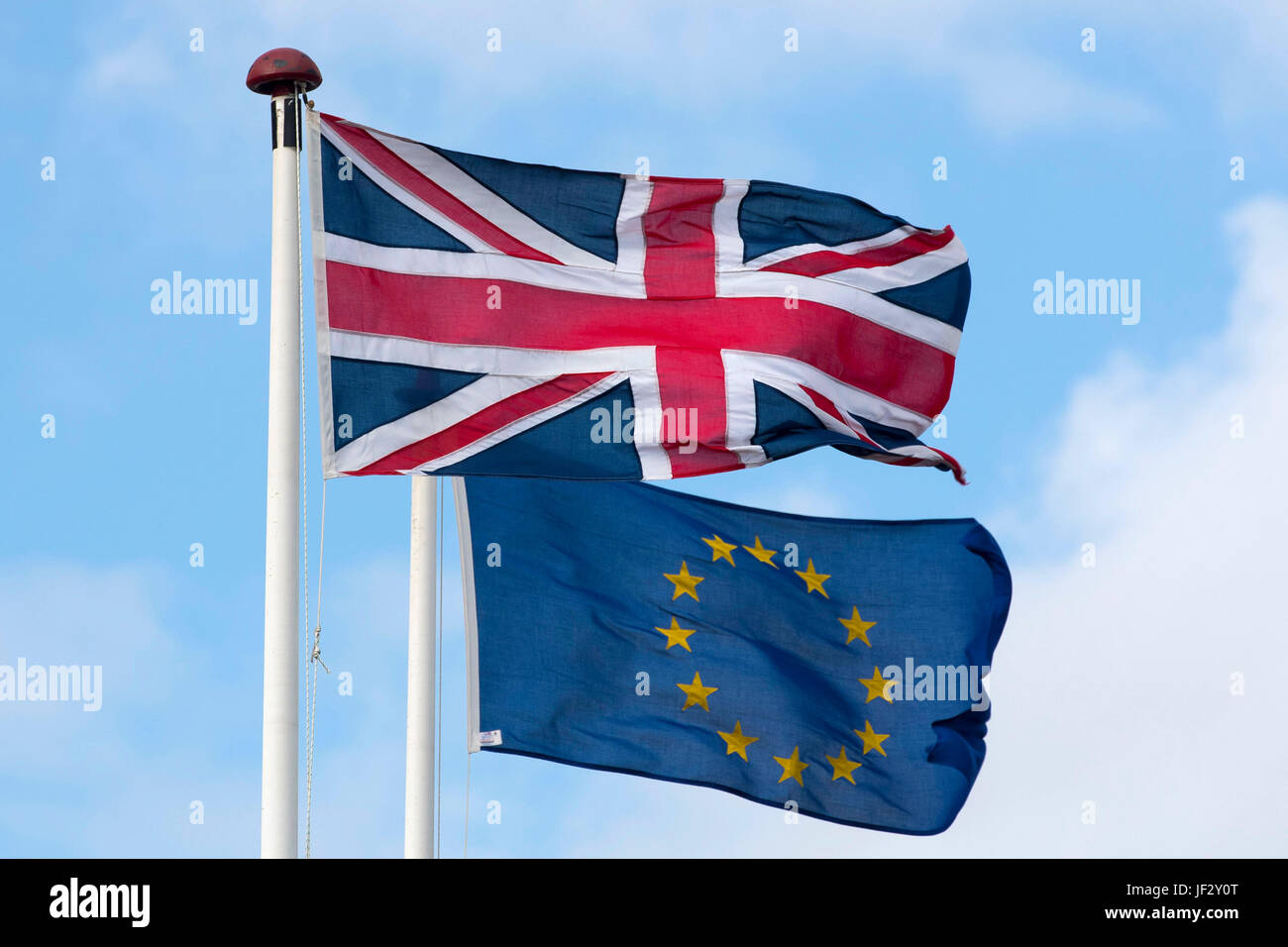 European Union and British Union Jack flags blow in the wind. The UK voted to leave the EU in a referendum. Stock Photo