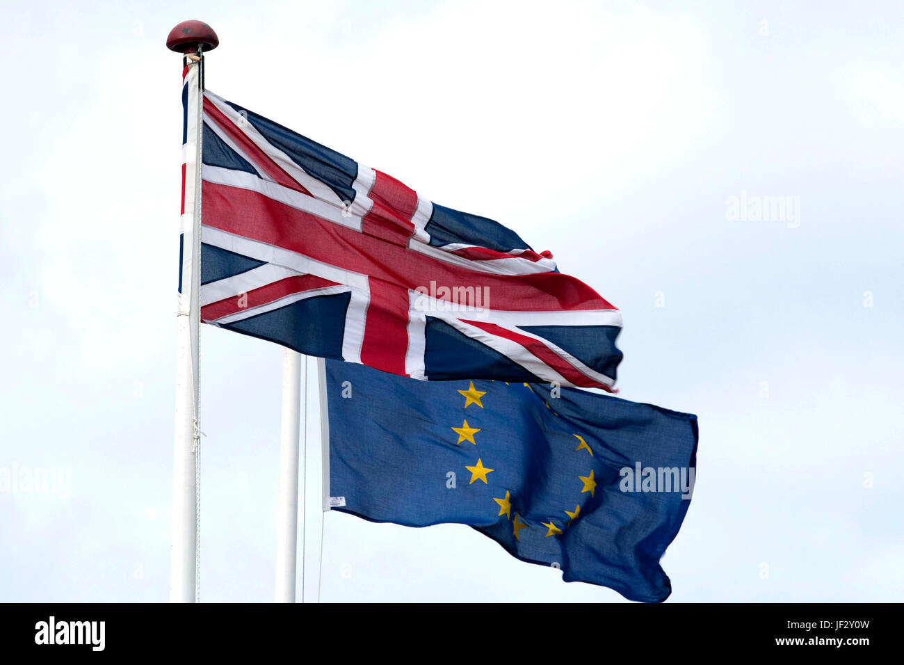 European Union and British Union Jack flags blow in the wind. The UK voted to leave the EU in a referendum. Stock Photo