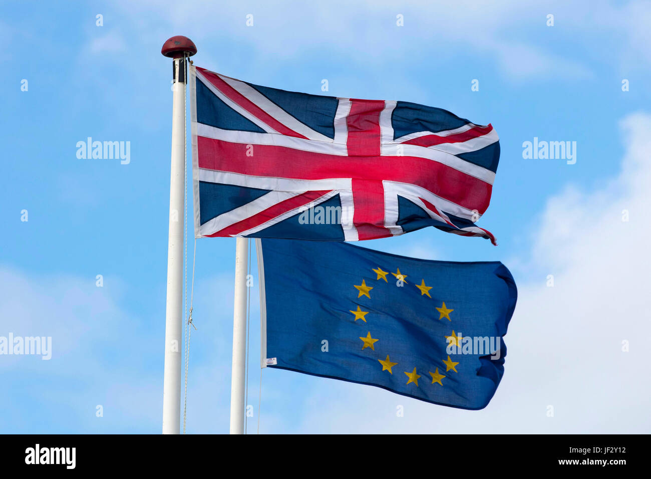 European Union and British Union Jack flags blow in the wind. The UK voted to leave the EU in a referendum. Stock Photo