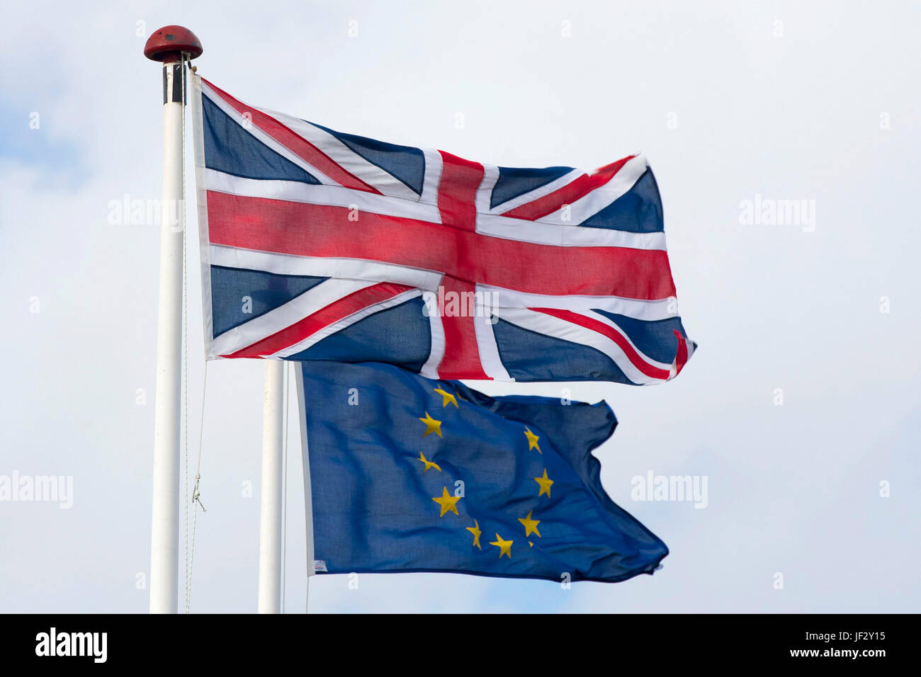 European Union and British Union Jack flags blow in the wind. The UK voted to leave the EU in a referendum. Stock Photo