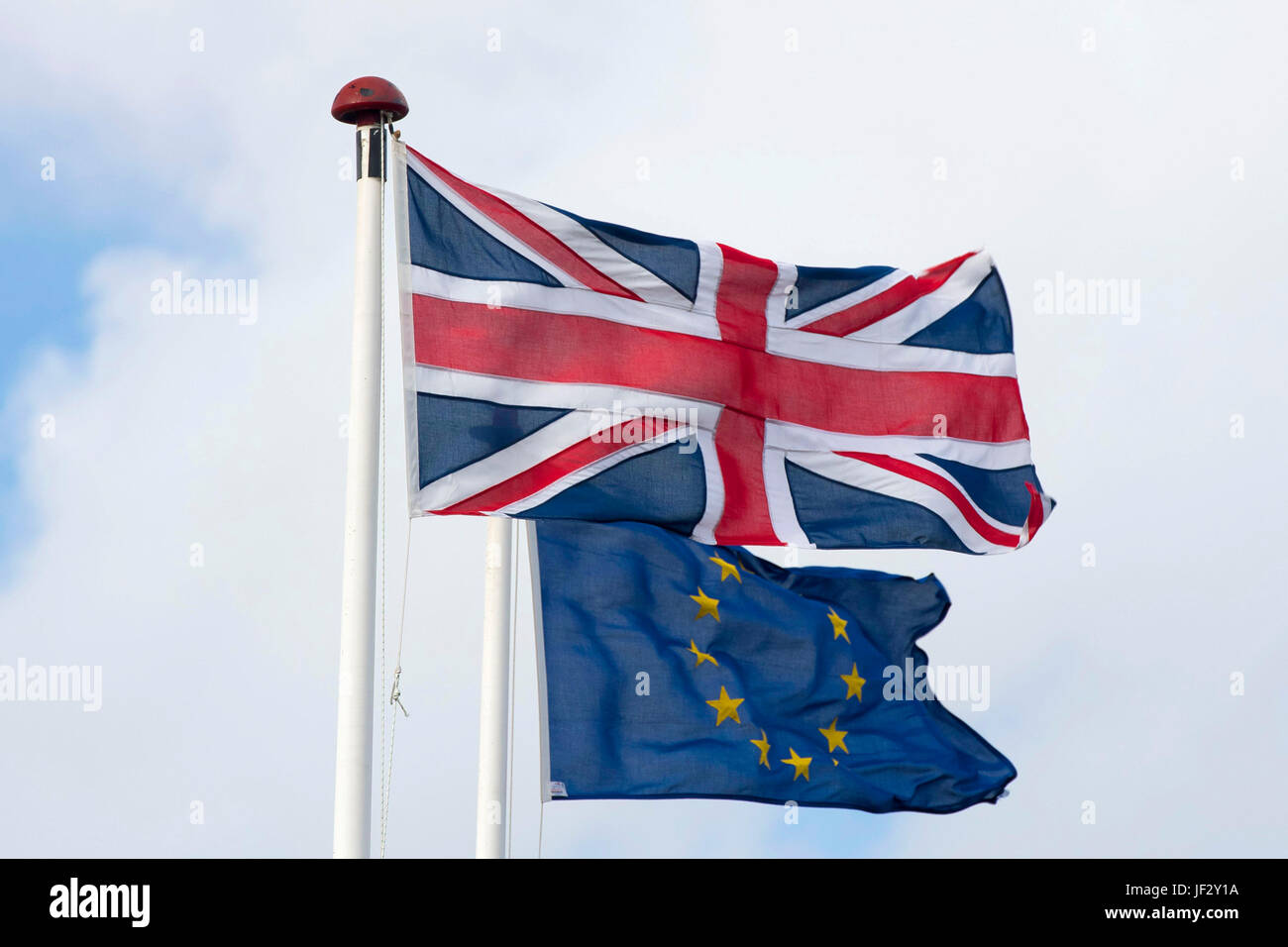 European Union and British Union Jack flags blow in the wind. The UK voted to leave the EU in a referendum. Stock Photo