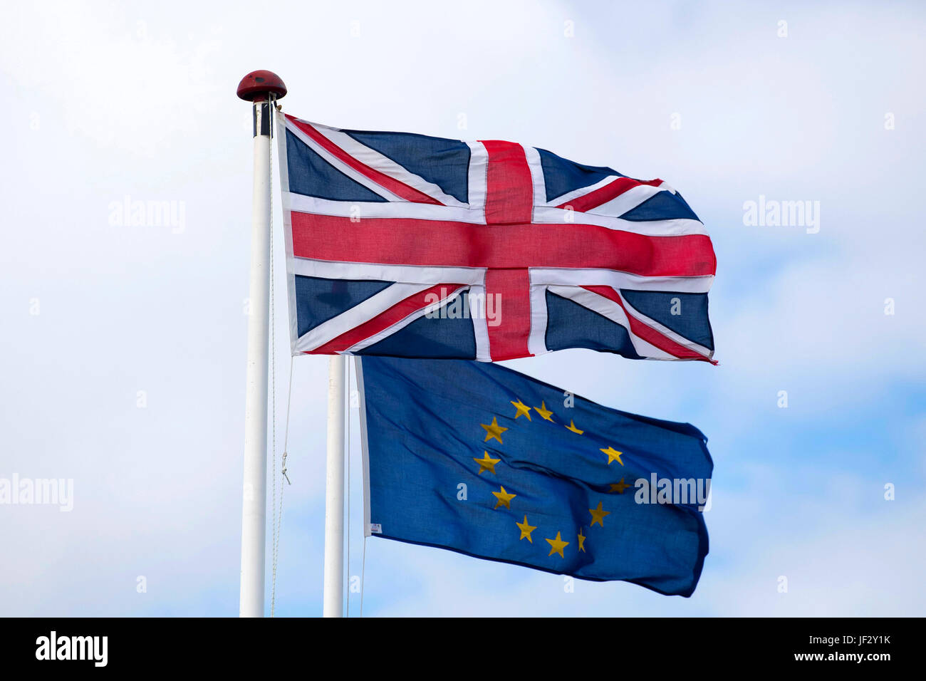 European Union and British Union Jack flags blow in the wind. The UK voted to leave the EU in a referendum. Stock Photo