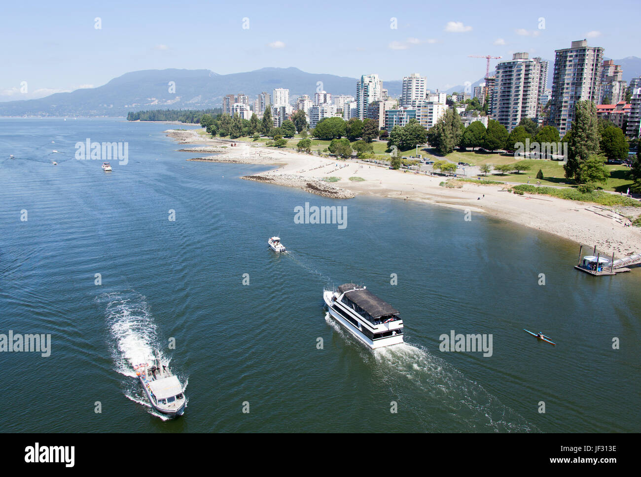 The view of busy False Creek water traffic and Sunset Beach park with ...
