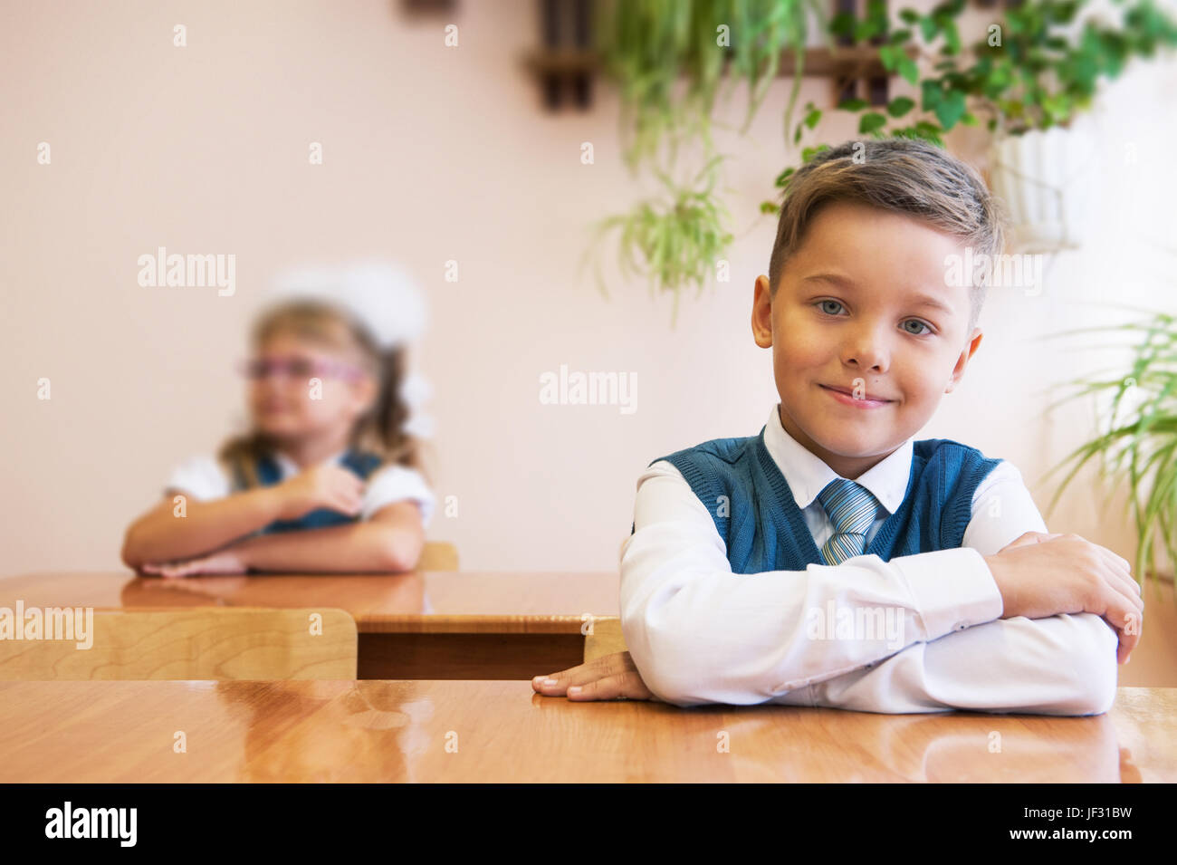 Happy schoolboy at school desk. Begining of learning Stock Photo - Alamy