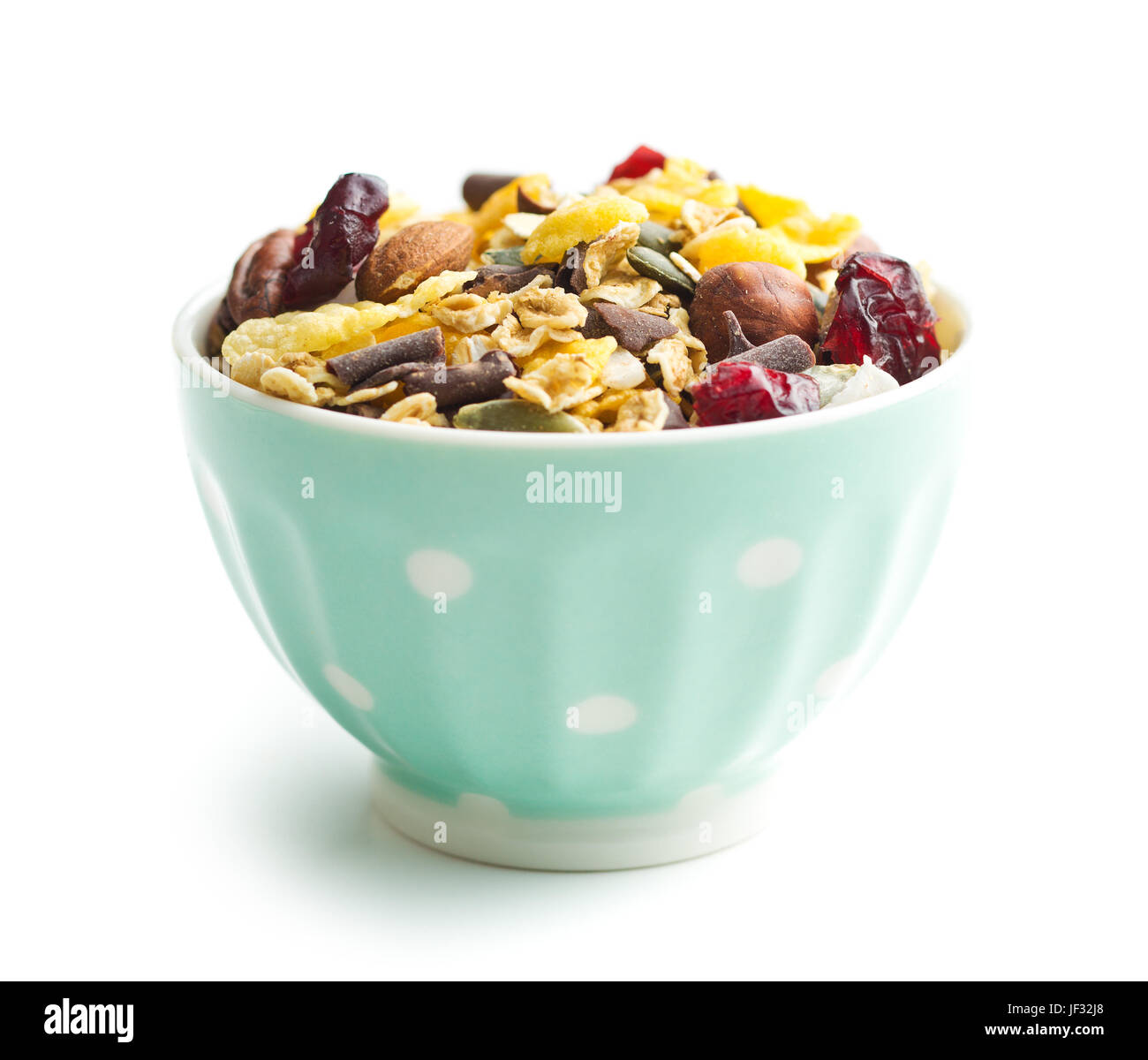 Tasty homemade muesli with nuts in bowl isolated on white background. Stock Photo