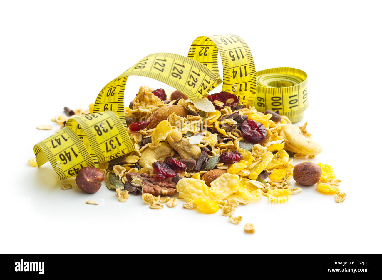 Tasty homemade muesli with nuts and measuring tape isolated on white background. Diet concept. Stock Photo