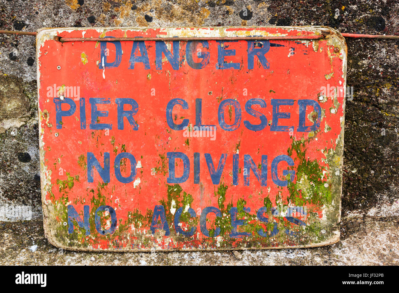 Old weathered sign warning against diving. St Abbs, Nothumberland, England Stock Photo
